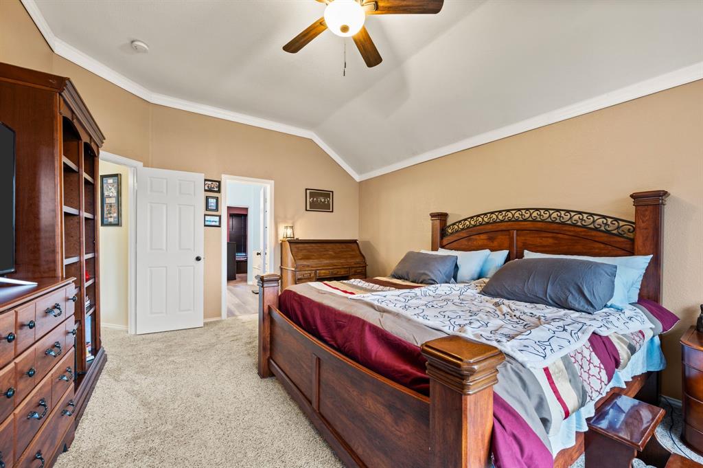 4008 Falcon Ridge Drive Haltom City, TX 76137 - Photo 21 of 32 a bedroom with a bed and a flat screen tv
