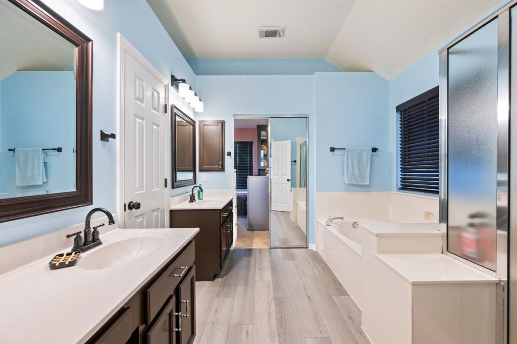 4008 Falcon Ridge Drive Haltom City, TX 76137 - Photo 22 of 32 a spacious bathroom with a tub sink and mirror