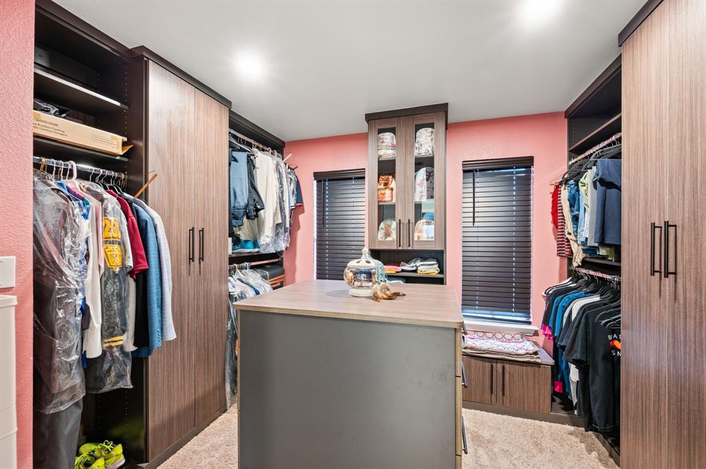 4008 Falcon Ridge Drive Haltom City, TX 76137 - Photo 24 of 32 a view of walk in closet with clothes and shoes