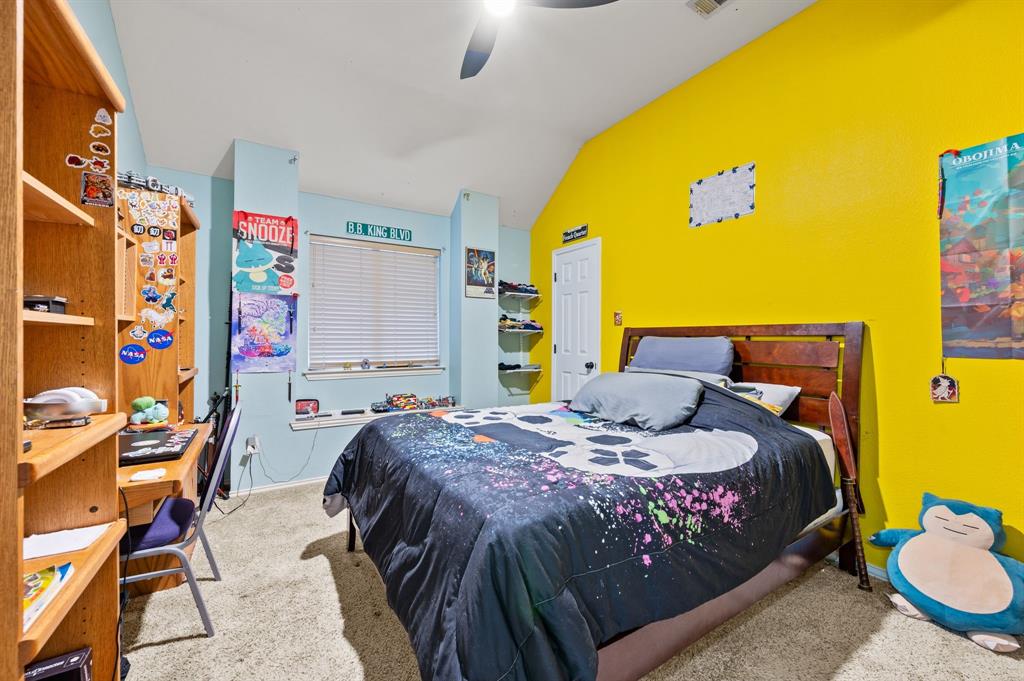 4008 Falcon Ridge Drive Haltom City, TX 76137 - Photo 26 of 32 a bedroom with a bed and dresser with wooden floor