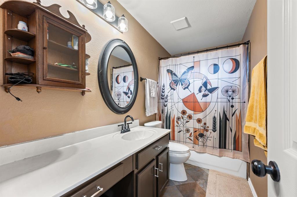 4008 Falcon Ridge Drive Haltom City, TX 76137 - Photo 27 of 32 a bathroom with a sink and a mirror