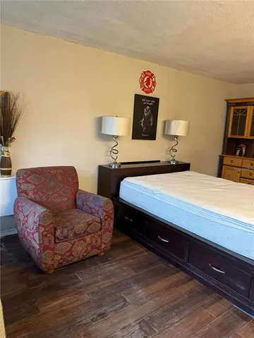 a bedroom with a bed and a night stand