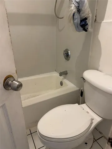 a bathroom with a toilet and a bathtub