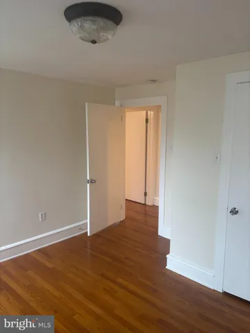 a view of an empty room and wooden floor