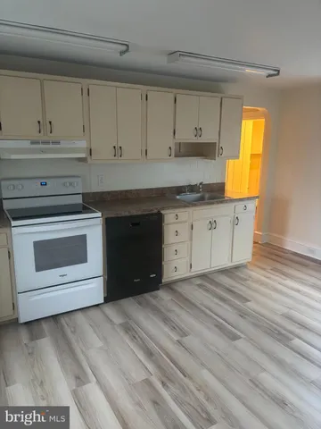 a kitchen with granite countertop a stove a sink and a granite counter tops