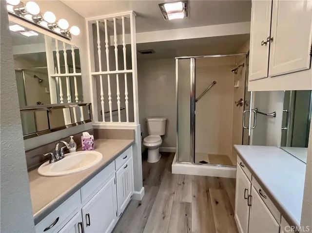 a bathroom with a sink a toilet and shower