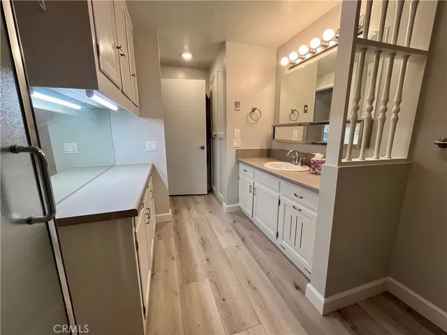 a kitchen with stainless steel appliances a refrigerator a sink a stove and cabinets