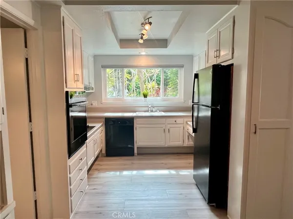a kitchen with stainless steel appliances a stove sink and refrigerator