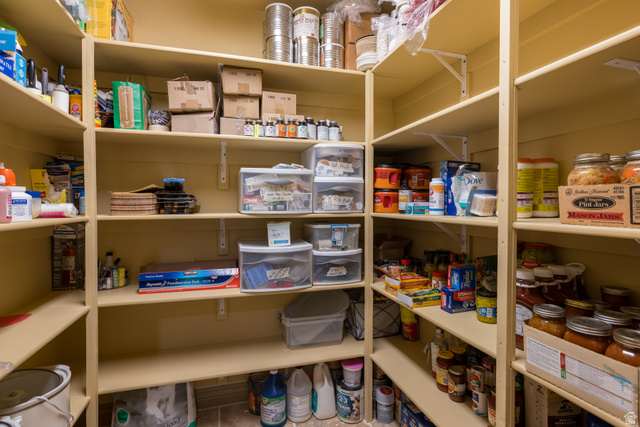 4635 East Sunny Acres Lane Moab, UT 84532 - Photo 34 of 56 Walk-in pantry featuring extensive built-in shelving, durable wood-finish construction, and ample storage capacity