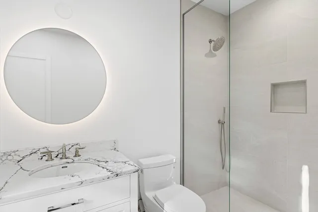 a bathroom with a sink toilet and shower