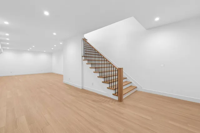 a view of a room with wooden floor