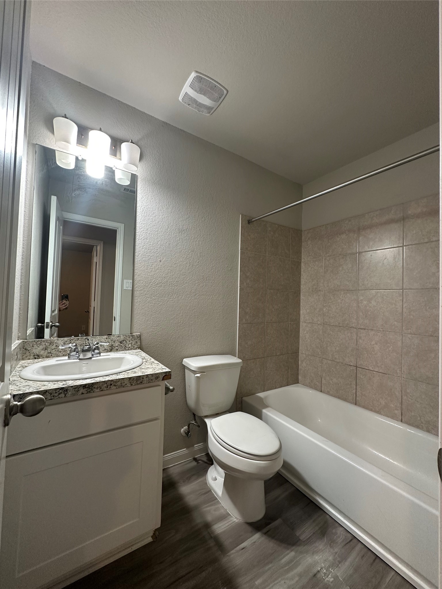 627 West Live Oak Street Angleton, TX 77515 - Photo 11 of 12 a bathroom with a toilet a sink and bathtub