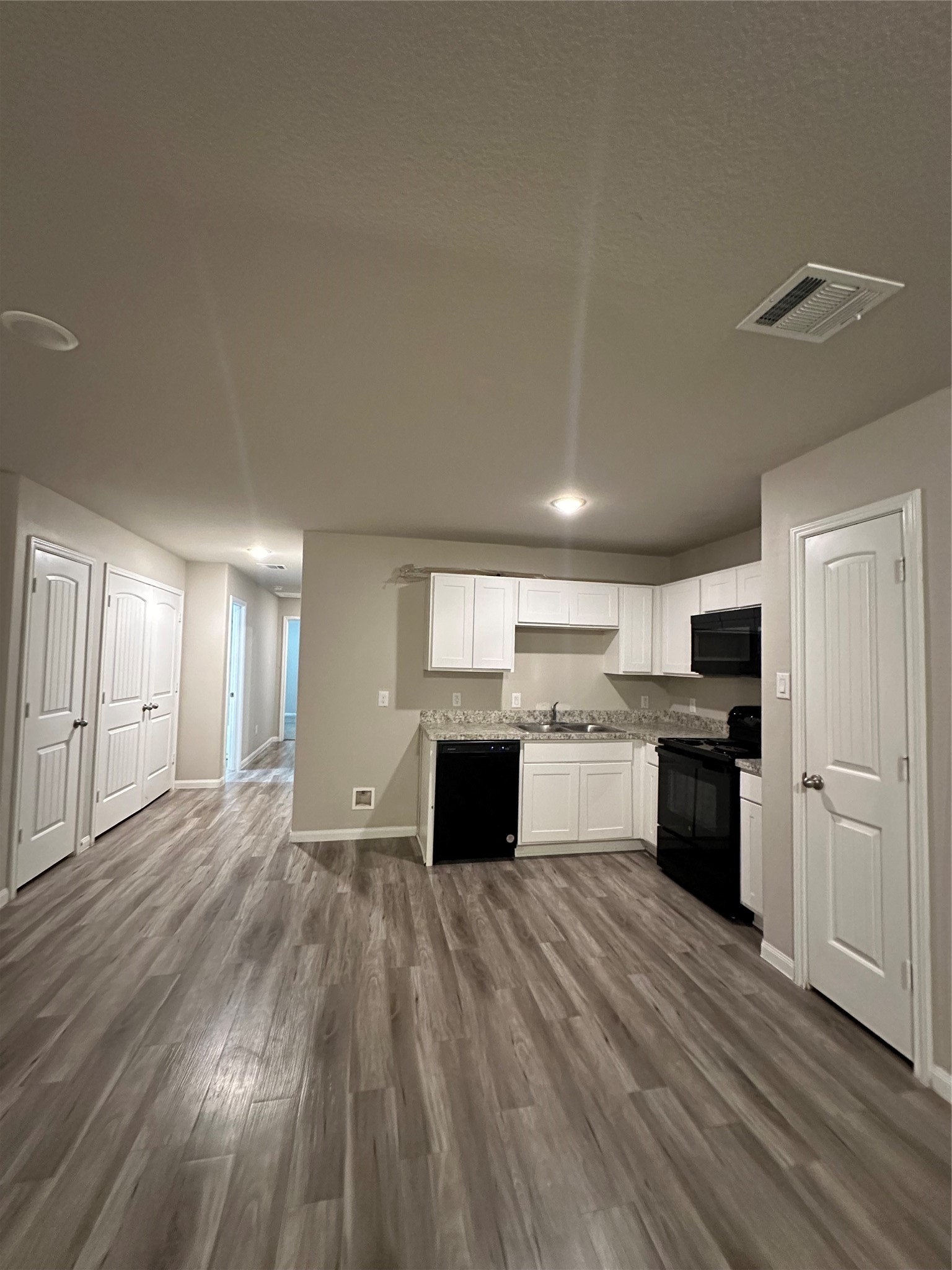 627 West Live Oak Street Angleton, TX 77515 - Photo 6 of 12 a kitchen with a refrigerator and a stove top oven