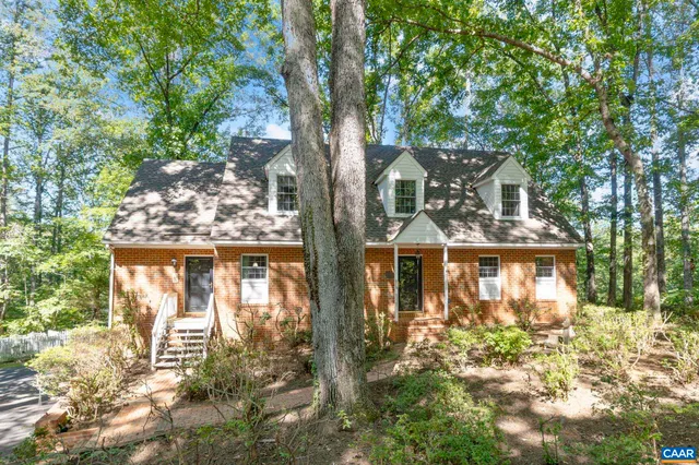 a room with stainless steel appliances kitchen island a table and chairs in it