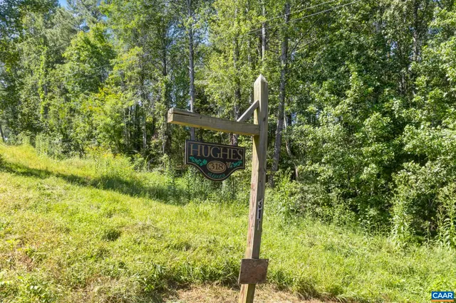 a living room with furniture a flat screen tv and a large window
