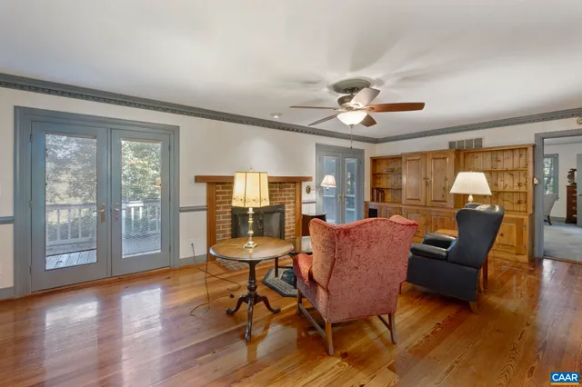 a kitchen with stainless steel appliances granite countertop a dining table chairs refrigerator and sink