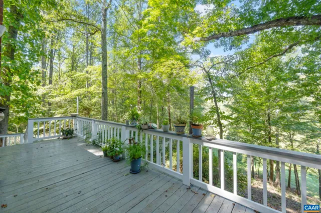 a bathroom with a tub a sink and a large mirror next to a window
