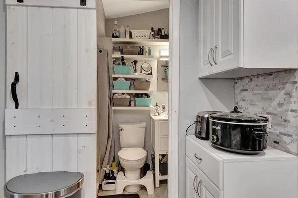 a bathroom with a sink a toilet and shower curtain