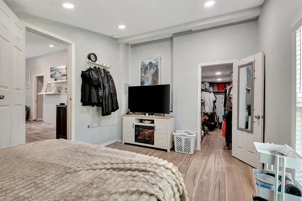 a view of walk in closet with clothes and shoes