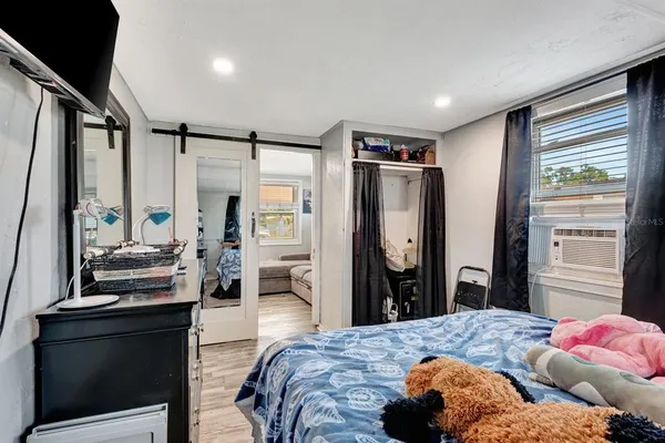 a bedroom with a bed window and dresser