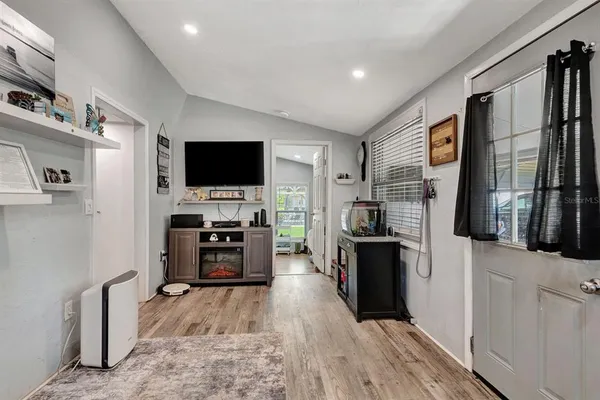 a bedroom with a bed dresser and window