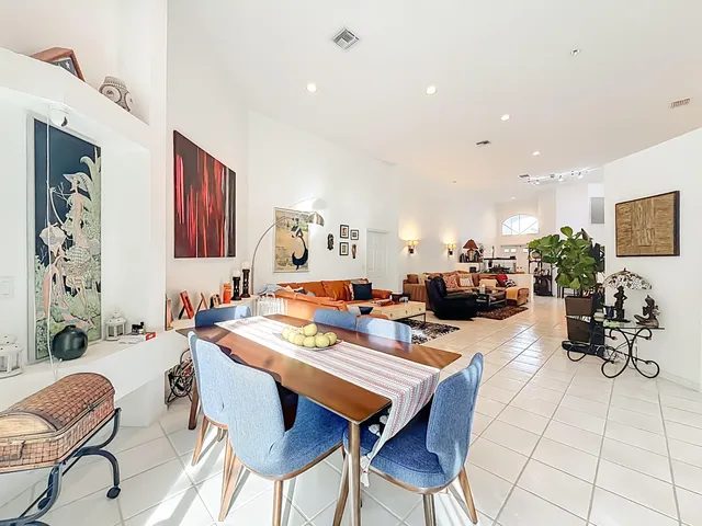 a living room with furniture a rug and a large window