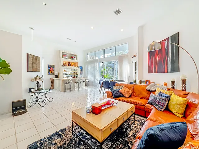 a living room with furniture gym equipment and a flat screen tv