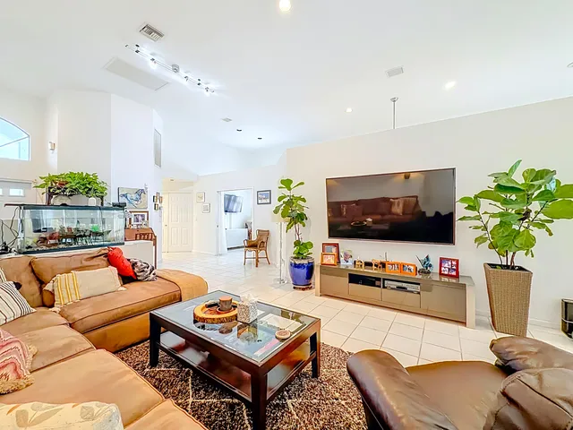 a dining room filled chandelier and wooden floor