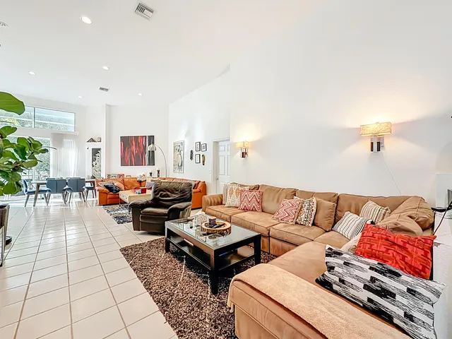 a kitchen with stainless steel appliances kitchen island granite countertop a refrigerator and a stove top oven