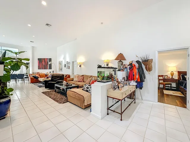 a kitchen with stainless steel appliances granite countertop sink stove and white cabinets with wooden floor