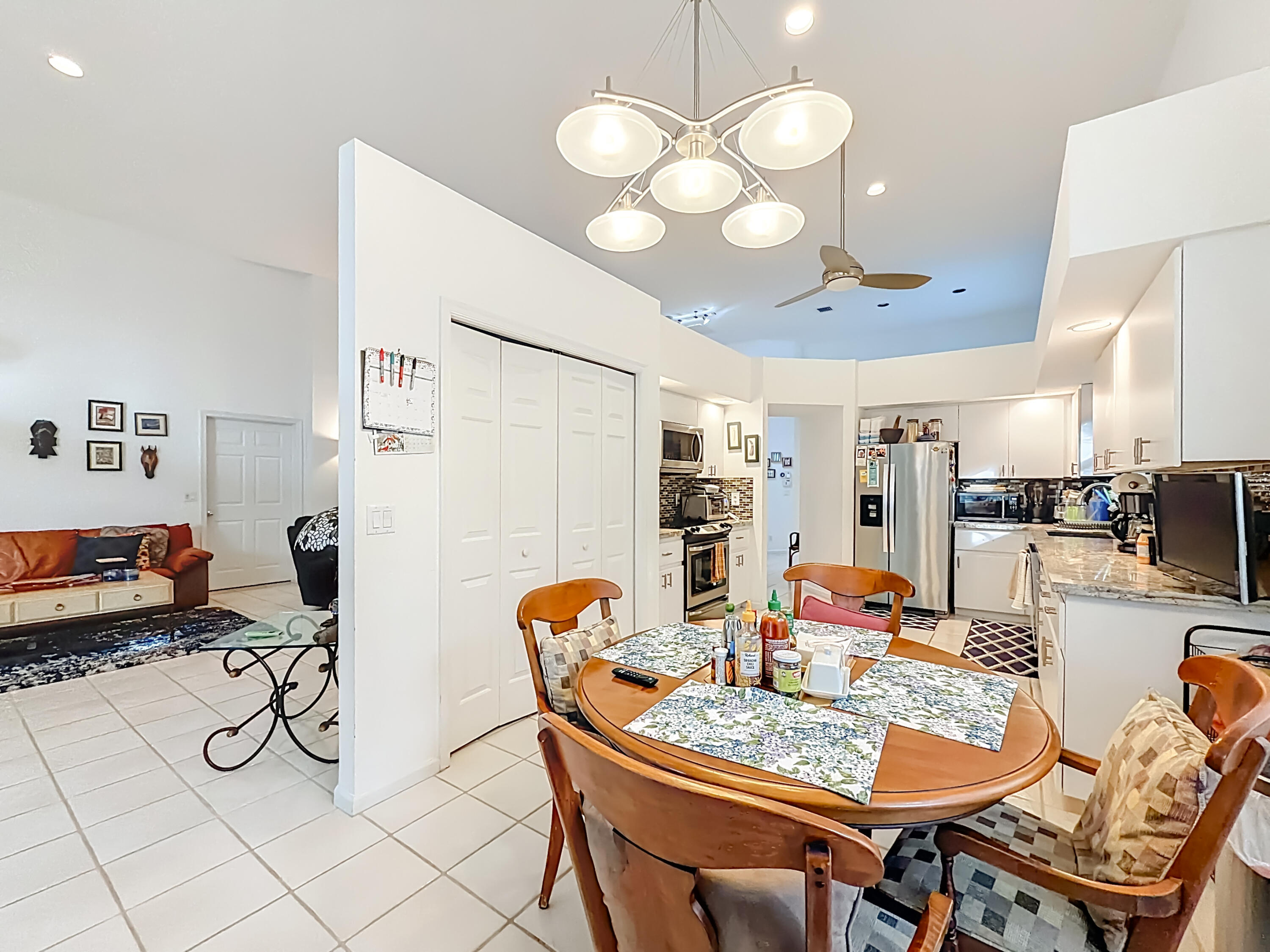 11853 Fountainside Circle Boynton Beach, FL 33437 - Photo 28 of 64 a view of a dining room with furniture and chandelier