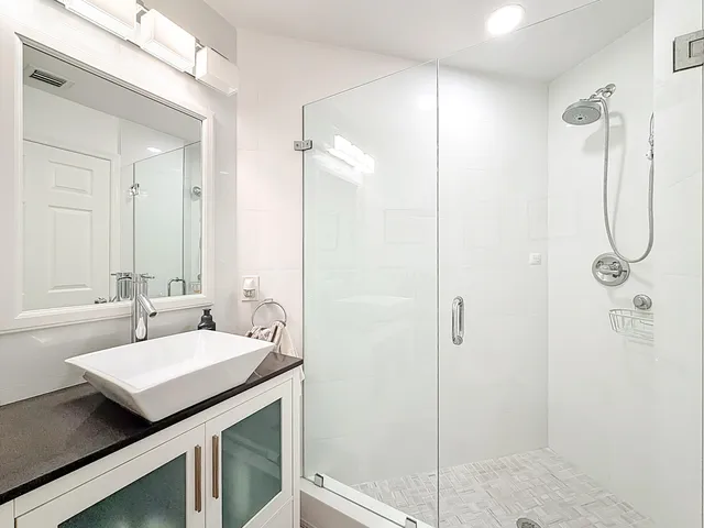 a bathroom with a sink vanity mirror and toilet
