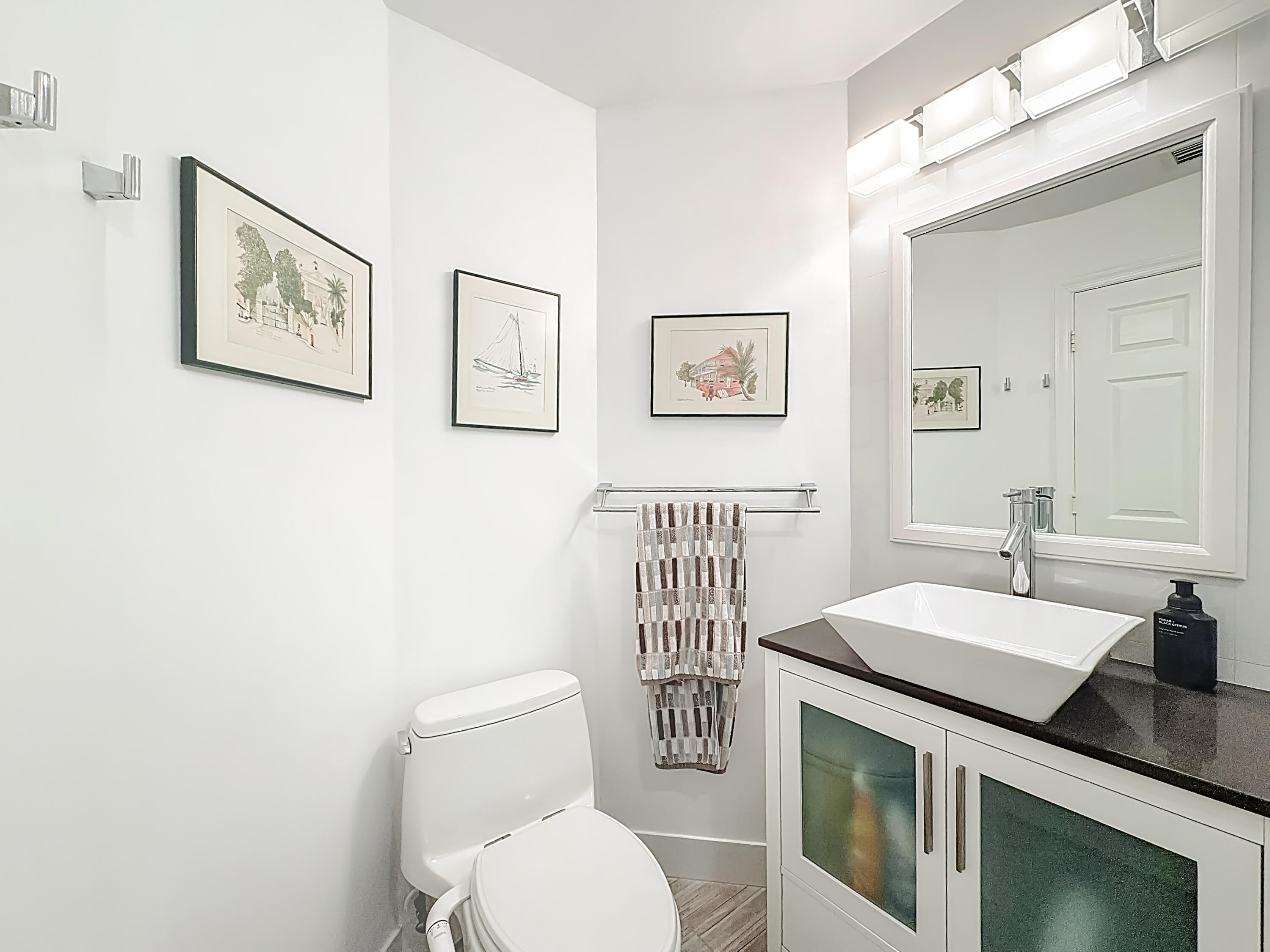 11853 Fountainside Circle Boynton Beach, FL 33437 - Photo 40 of 64 a bathroom with a toilet a sink and mirror