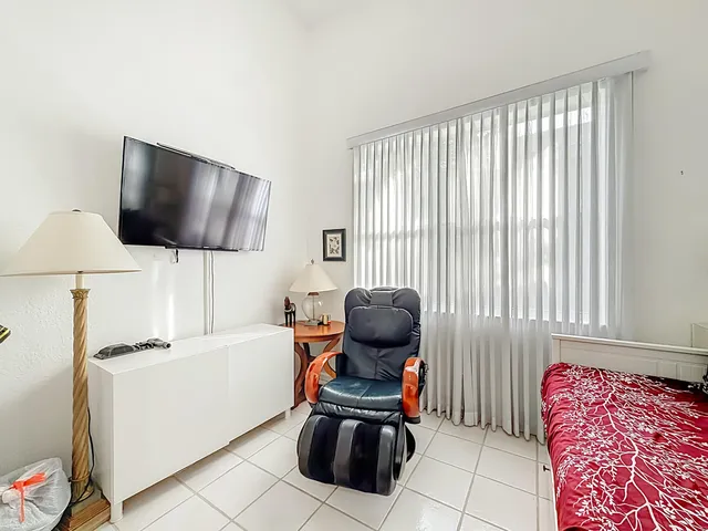 a large white kitchen with a sink and cabinets