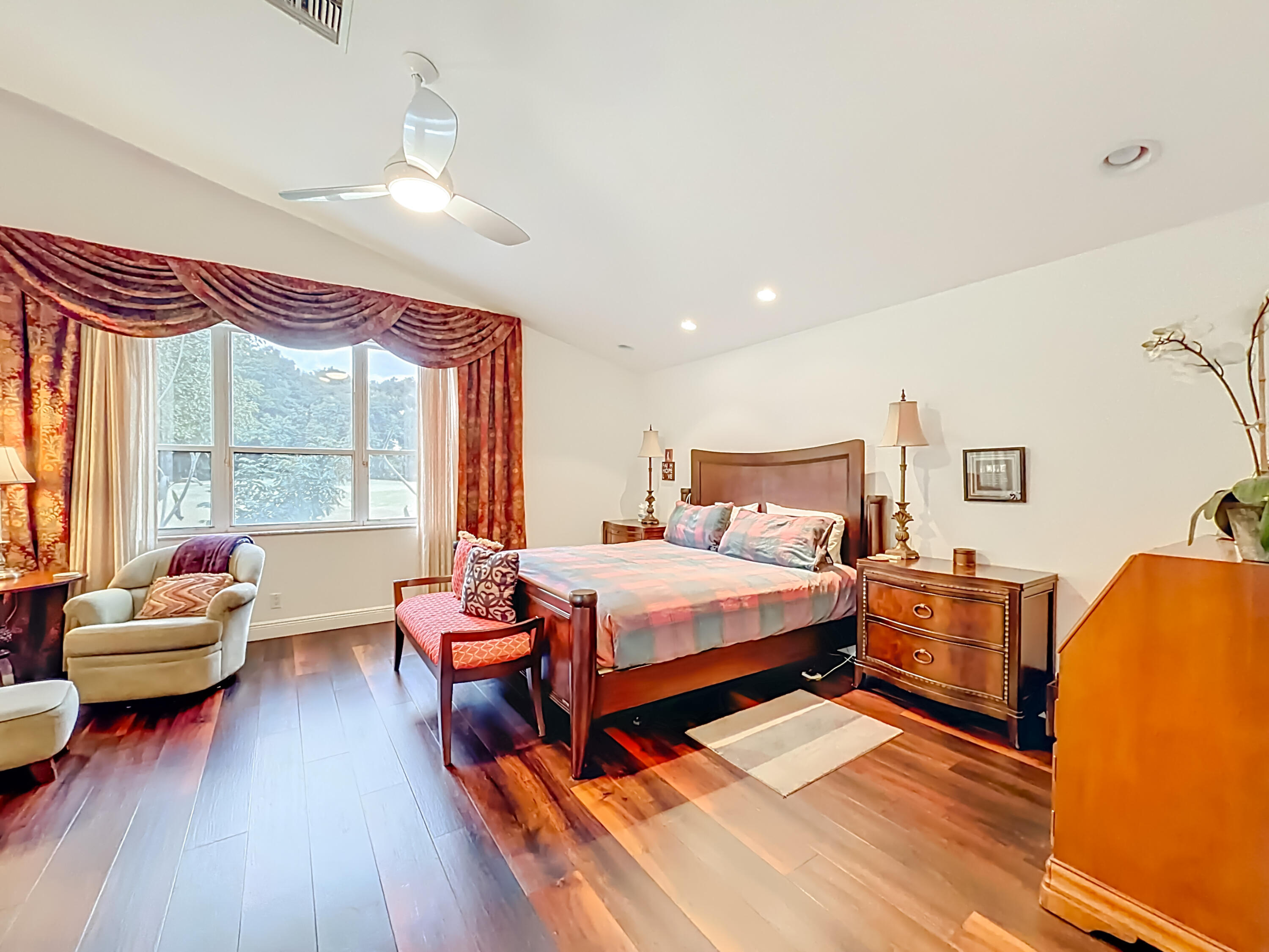 11853 Fountainside Circle Boynton Beach, FL 33437 - Photo 56 of 64 a bedroom with a bed and wooden floor