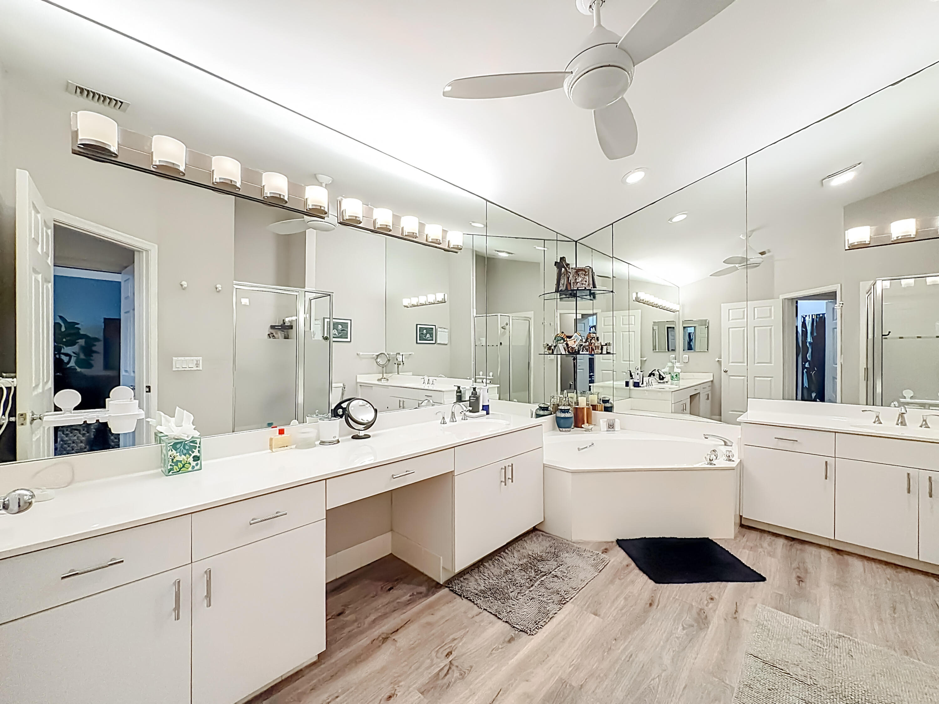 11853 Fountainside Circle Boynton Beach, FL 33437 - Photo 58 of 64 a large white kitchen with a white center island a sink stainless steel appliances and cabinets