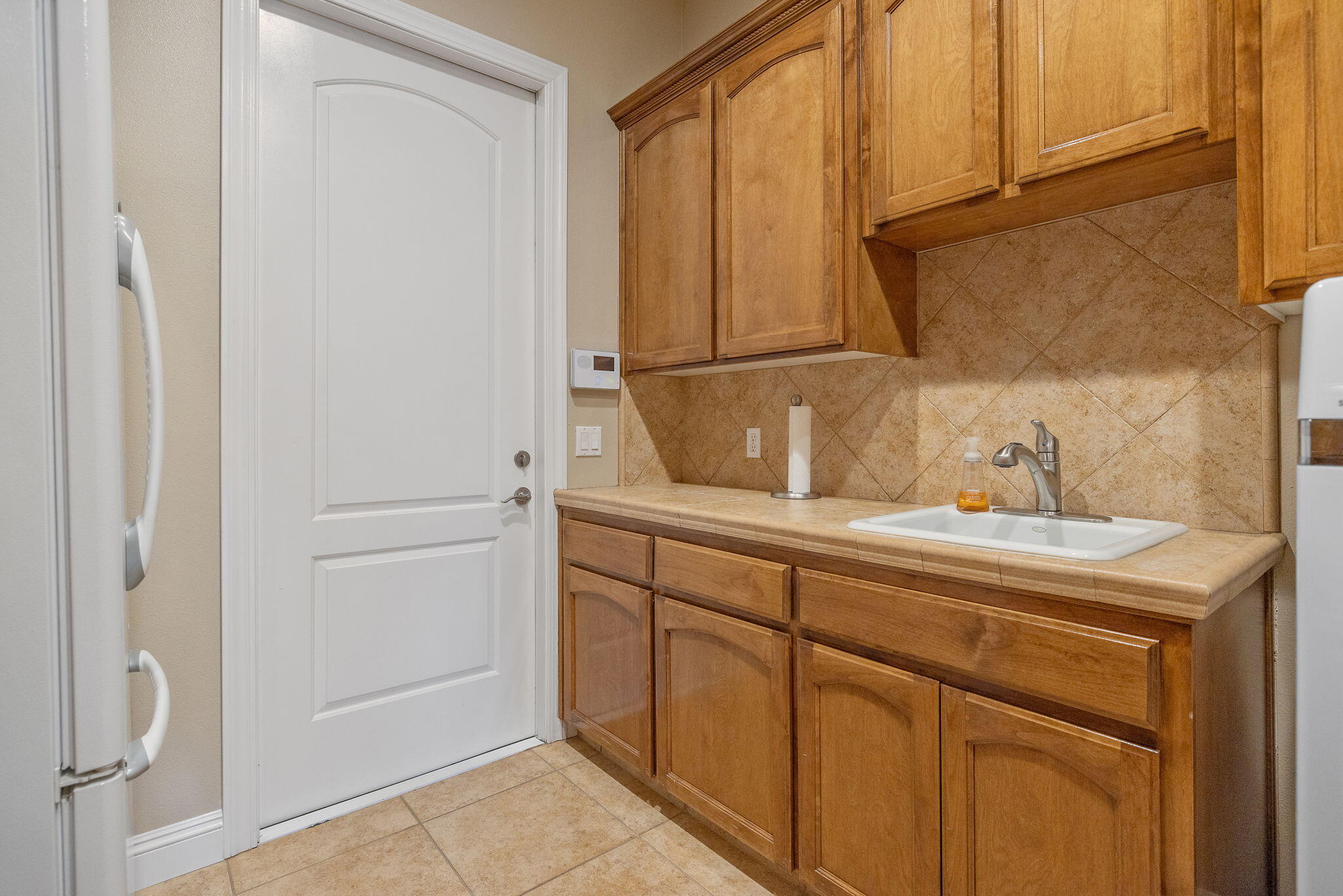 760 St James Court Exeter, CA 93221 - Photo 45 of 77 presoak sink, and garage door.