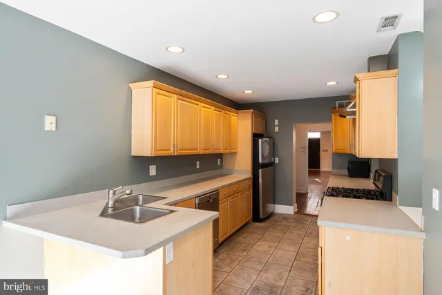 a kitchen that has a sink and a stove