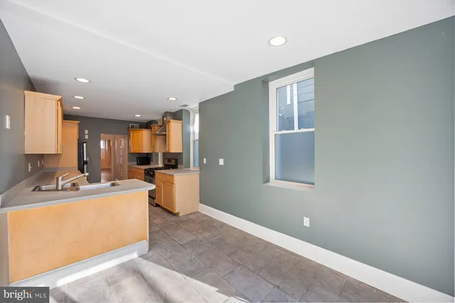 a large white room with a large window and couch