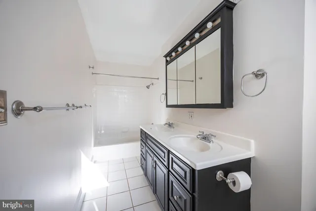 a bathroom with a sink vanity and a mirror