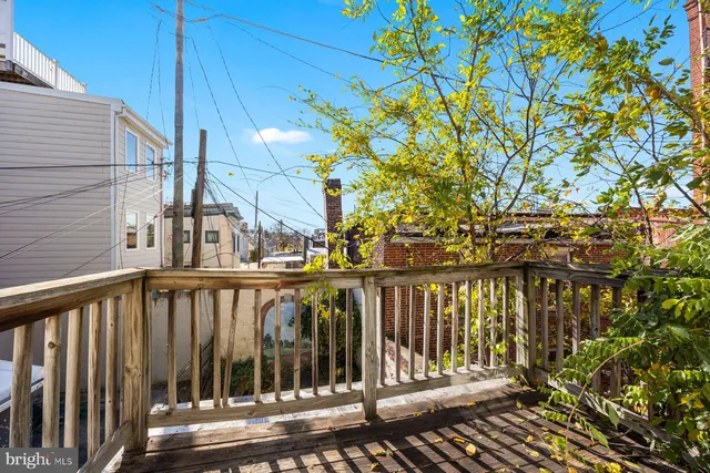 a view of balcony with wooden floor and fence