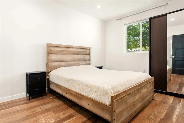 a bed sitting in a bedroom next to a window