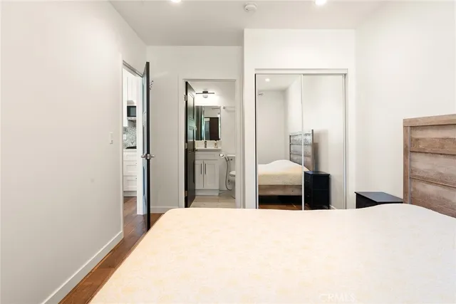 a bedroom with a bed and a large mirror