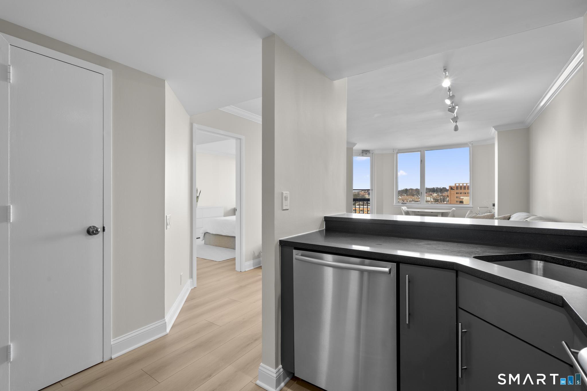 25 Forest Street, Unit 15E Stamford, CT 06901 - Photo 12 of 40 a kitchen with a sink a stove and cabinets