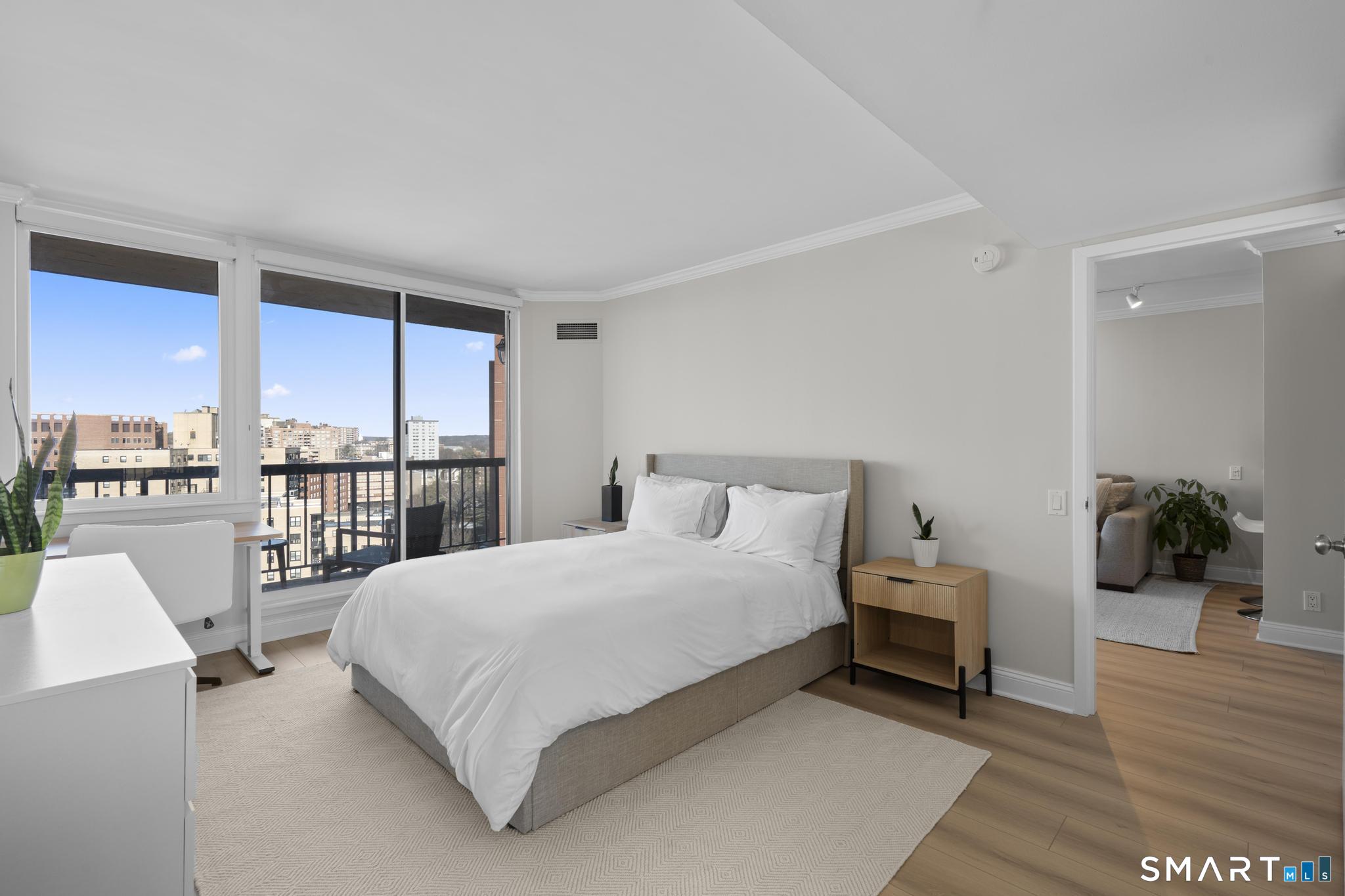 25 Forest Street, Unit 15E Stamford, CT 06901 - Photo 13 of 40 a bedroom with a bed and large windows