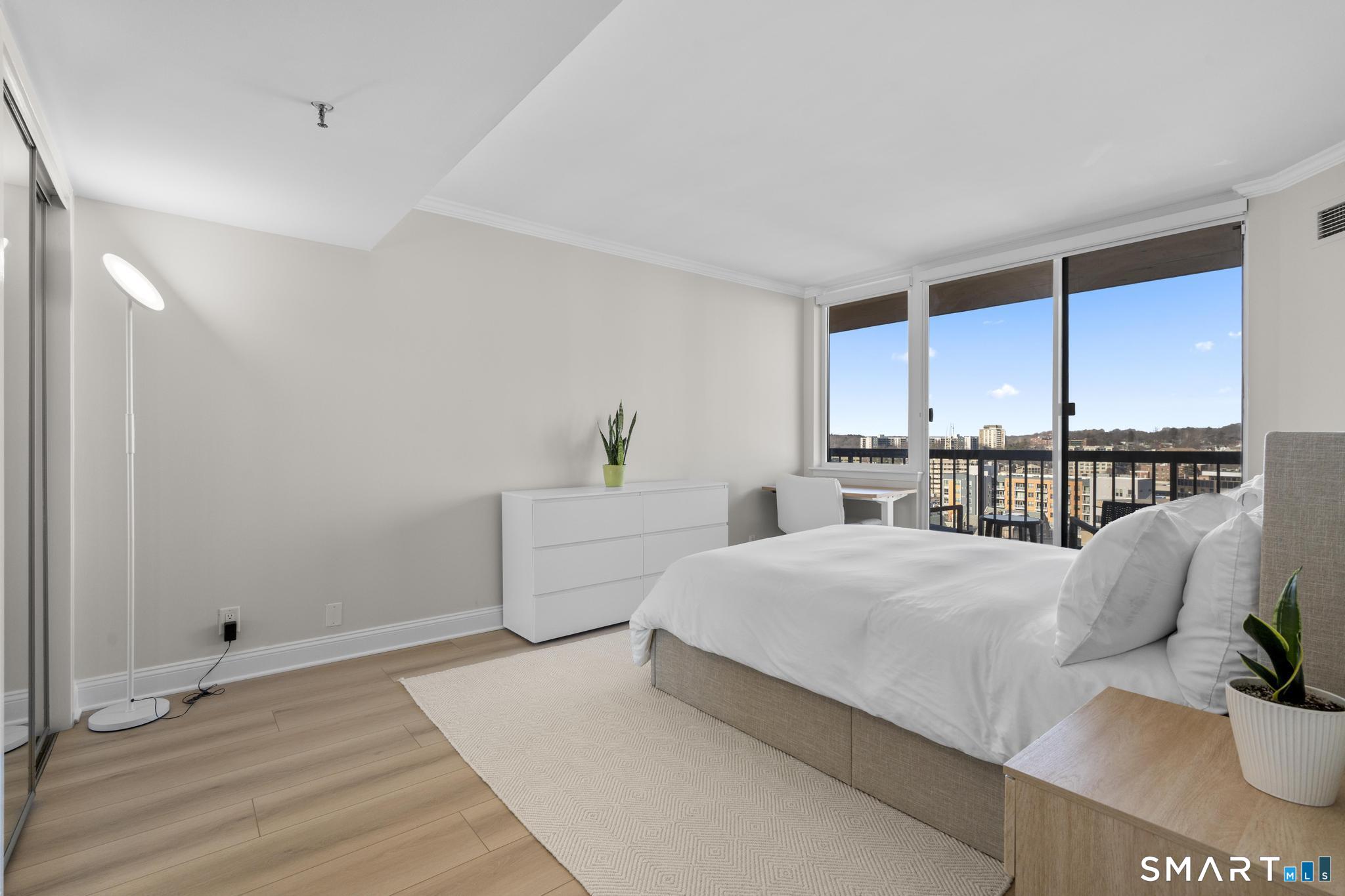 25 Forest Street, Unit 15E Stamford, CT 06901 - Photo 15 of 40 a living room with furniture and a table