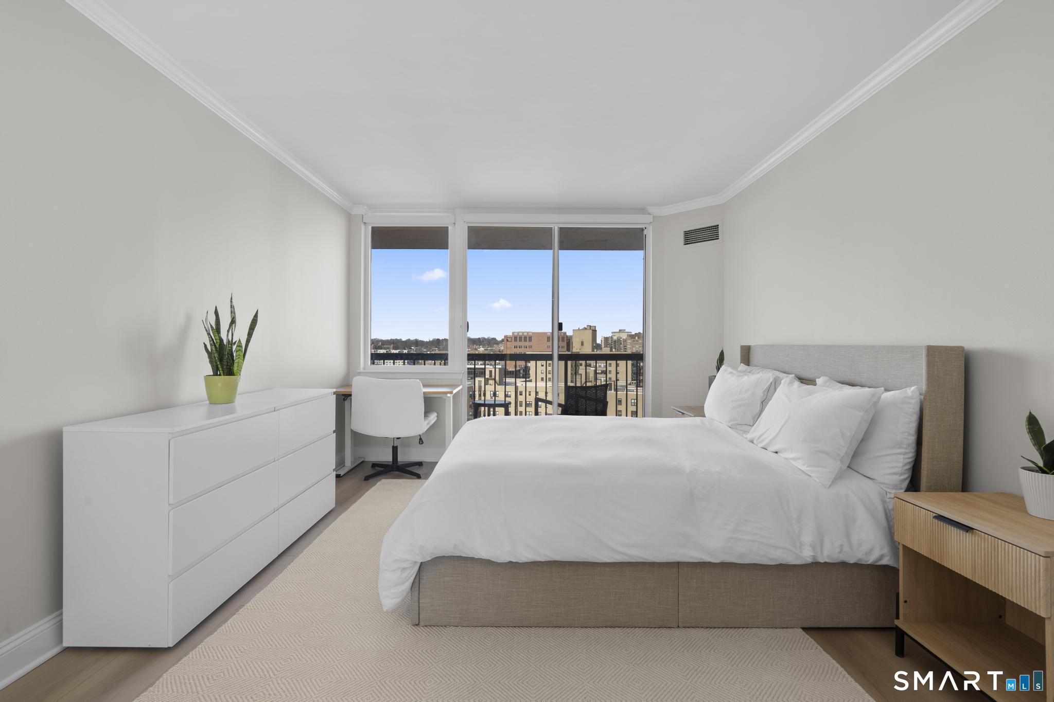 25 Forest Street, Unit 15E Stamford, CT 06901 - Photo 16 of 40 a spacious bedroom with a bed and a cabinets