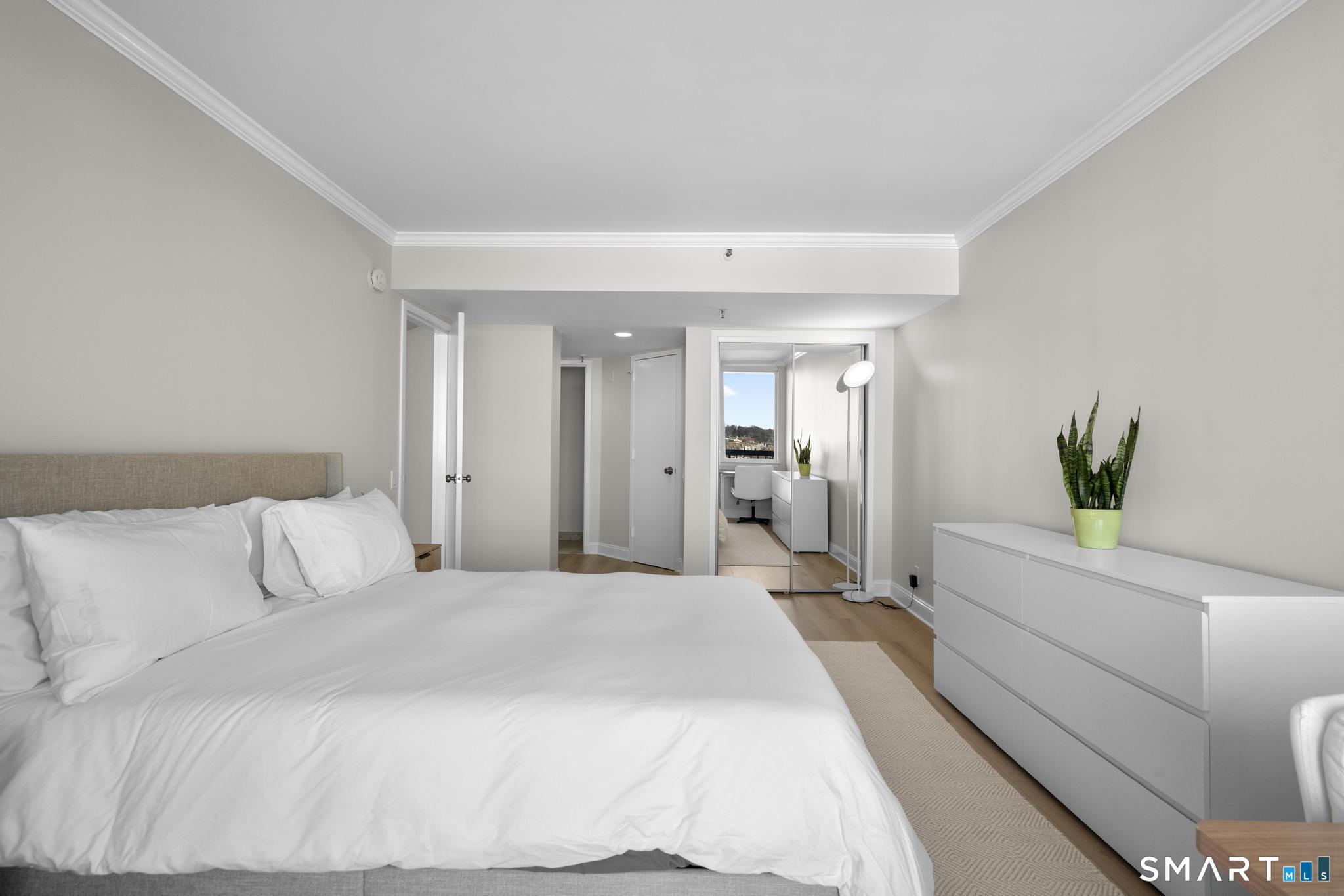 25 Forest Street, Unit 15E Stamford, CT 06901 - Photo 17 of 40 a bedroom with a bed and a couch