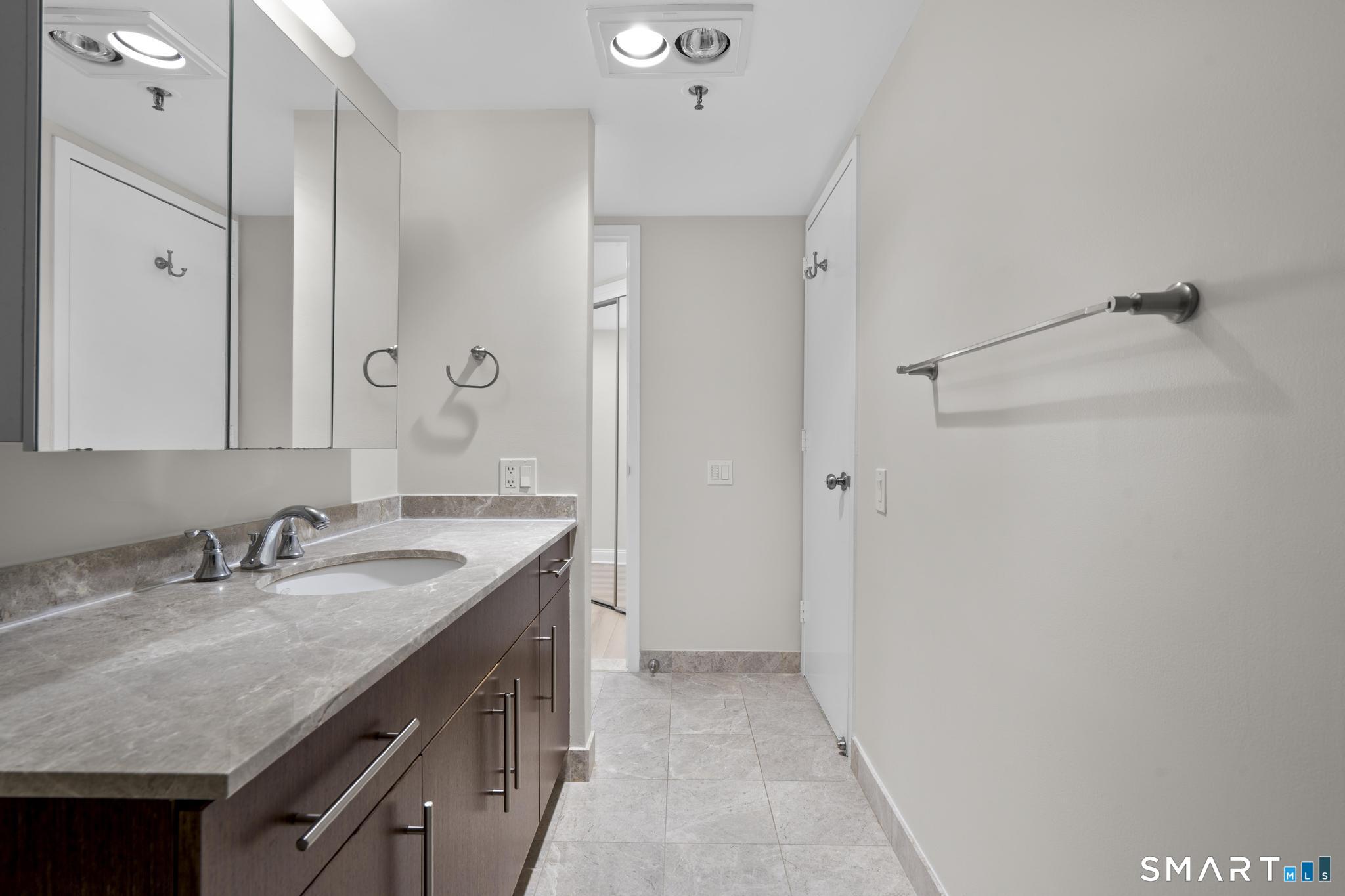 25 Forest Street, Unit 15E Stamford, CT 06901 - Photo 19 of 40 a bathroom with 2 sink and a mirror