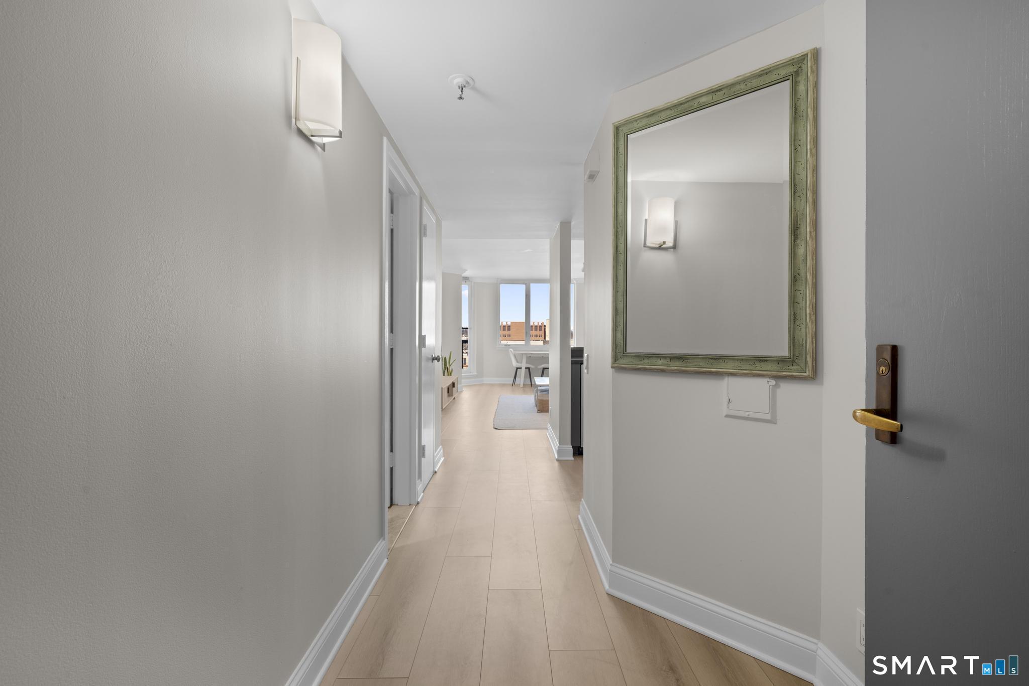 25 Forest Street, Unit 15E Stamford, CT 06901 - Photo 24 of 40 a view of a hallway with wooden floor